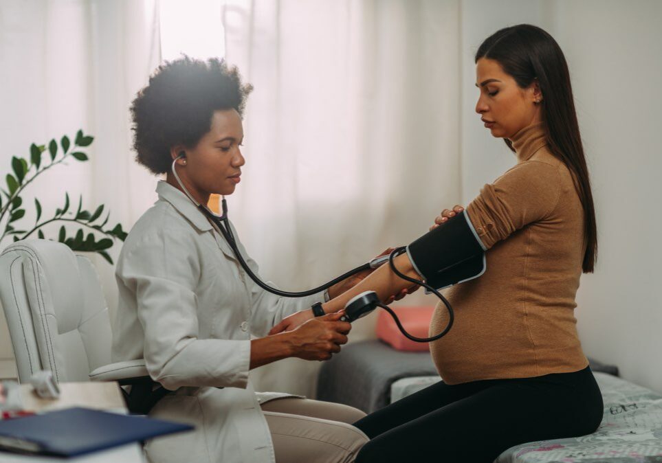 Doctor measuring blood pressure wide